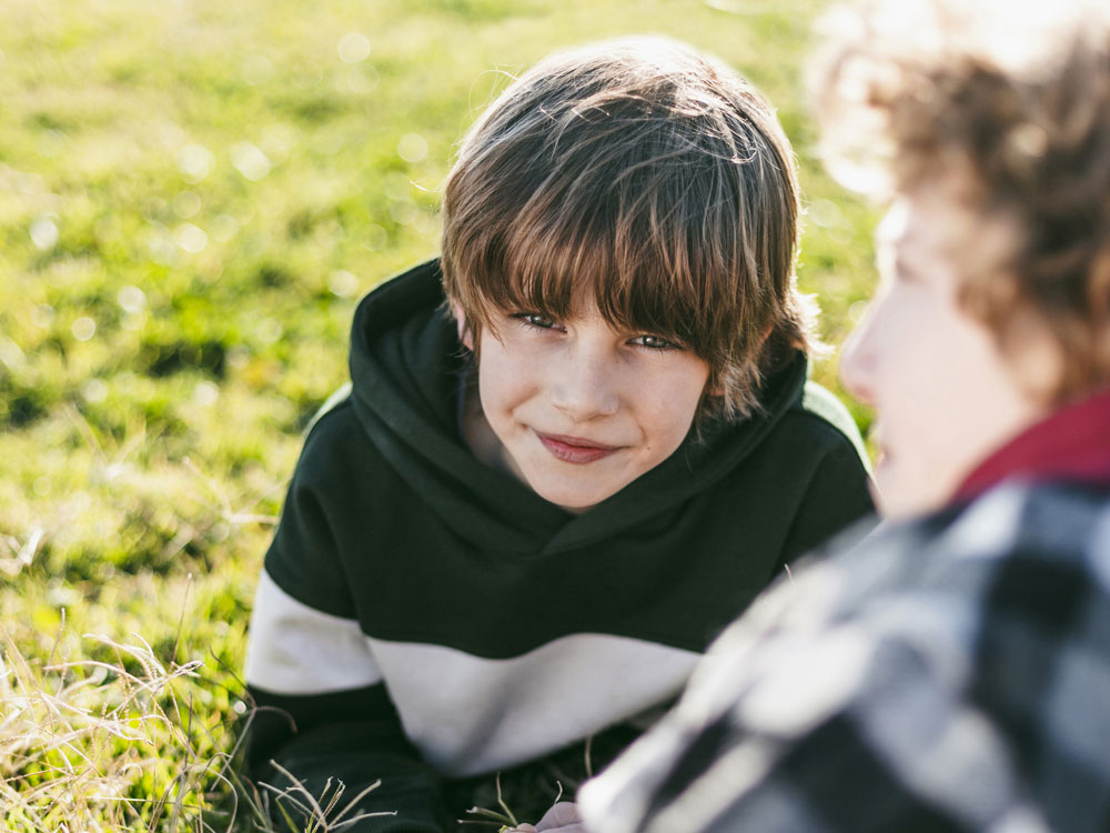 smiley-boy-with-his-friend-grass-outdoors